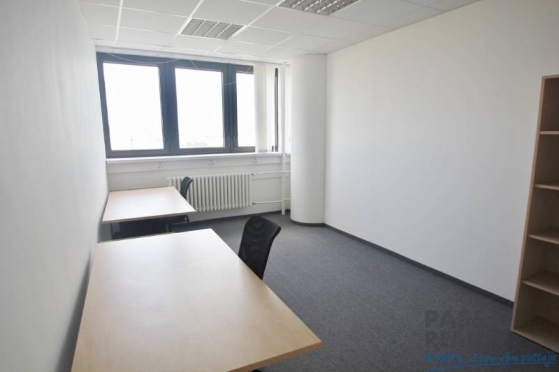 Offices with simple furniture, white walls and a large window, carpet.