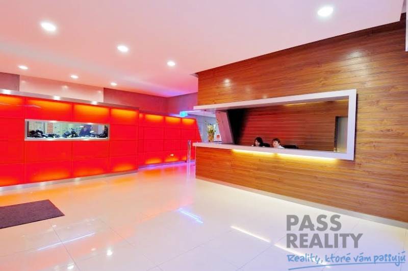 Offices with light flooring and a reception area in decorative wooden style.