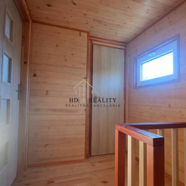 The interior of a cabin with wooden paneling and a floor with a wood decor.