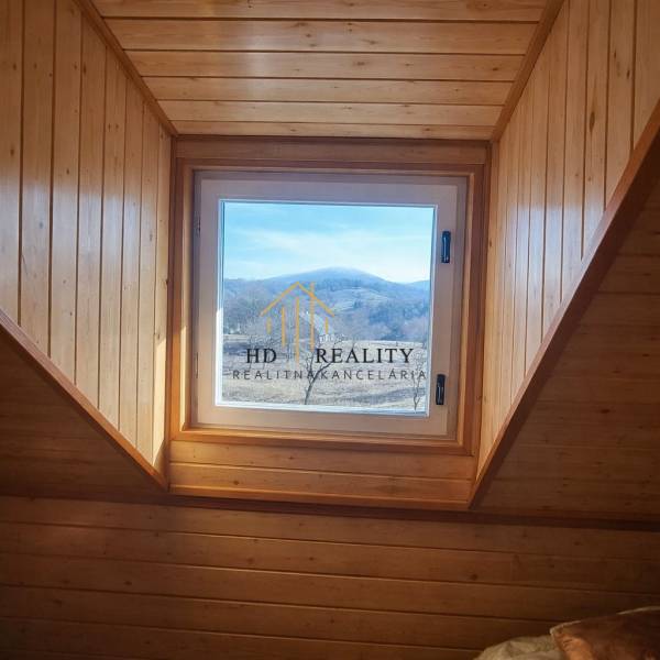 Windows with a view of the hills, wood-paneled, Cabin.