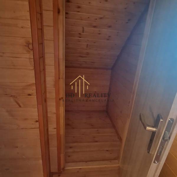 Wooden interior in a cabin with wooden decor and a staircase.