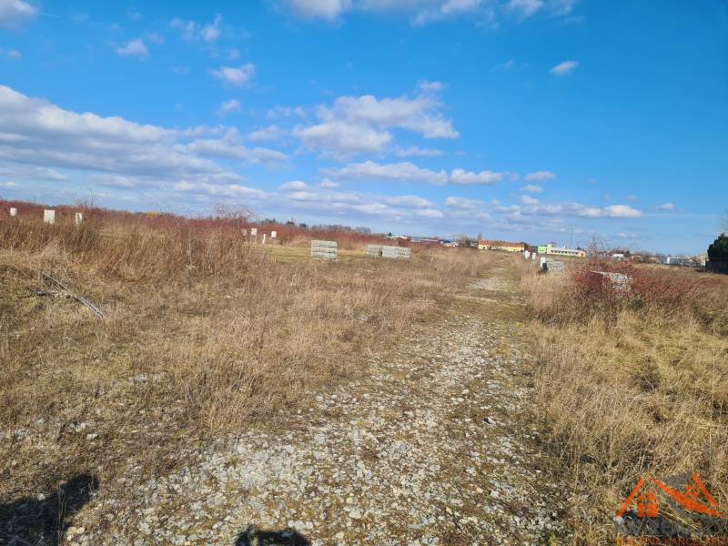 Residential plots in Nové Zámky with natural vegetation and a clear sky.
