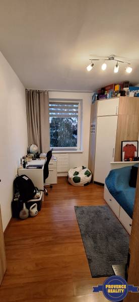 Children's room in a 4-room apartment with a desk, bed, and floor with a wooden decor.