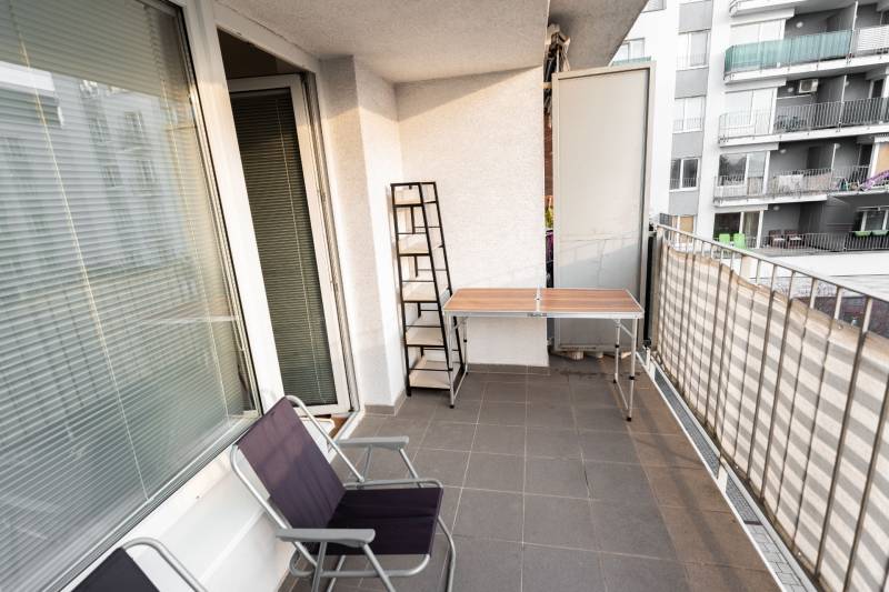Balcony with a terrace, table, and chairs at a 2-room apartment on Hrachova Street in Bratislava.