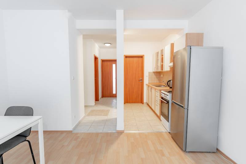 A kitchen with a dining table in a 2-room apartment, floor with wood decor.