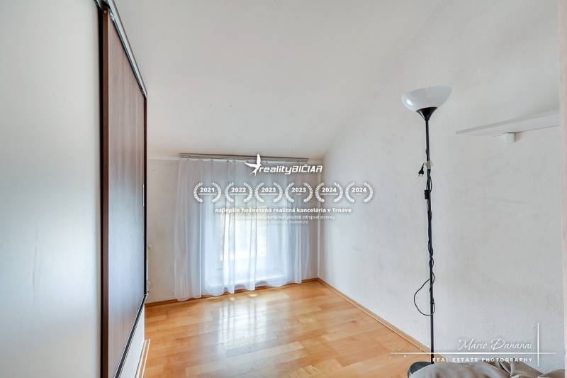 A room in a family house with a wooden decor floor and a cabinet.