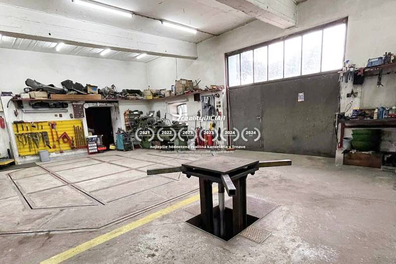 Workshop with tools, workbench, and pit, without people. Family house.