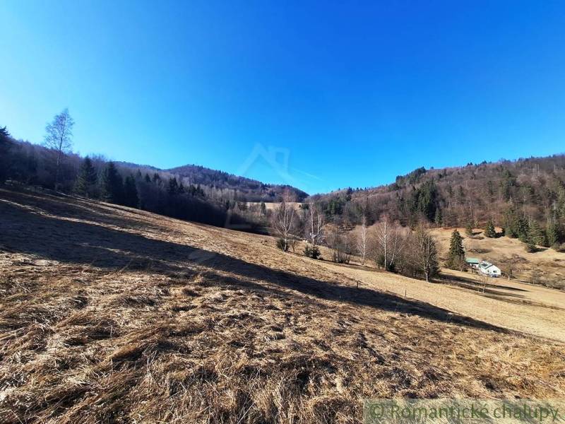 Hilly landscape with forests and meadows around Hronec on agricultural and forest lands.