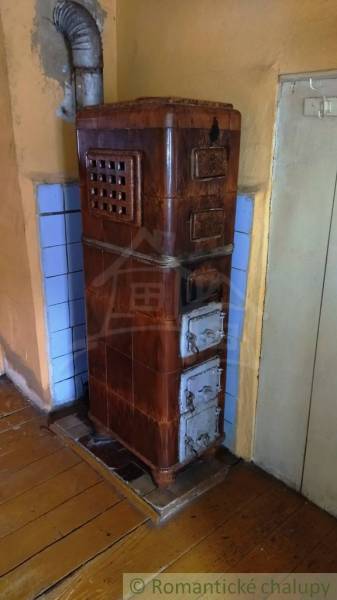 Tiled stove in a family house with a wooden decor floor.