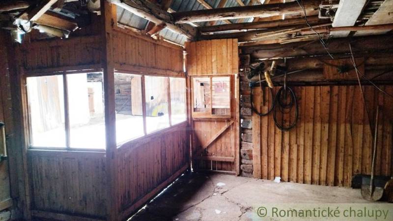 Interior of a family house with wooden decor and windows without curtains.