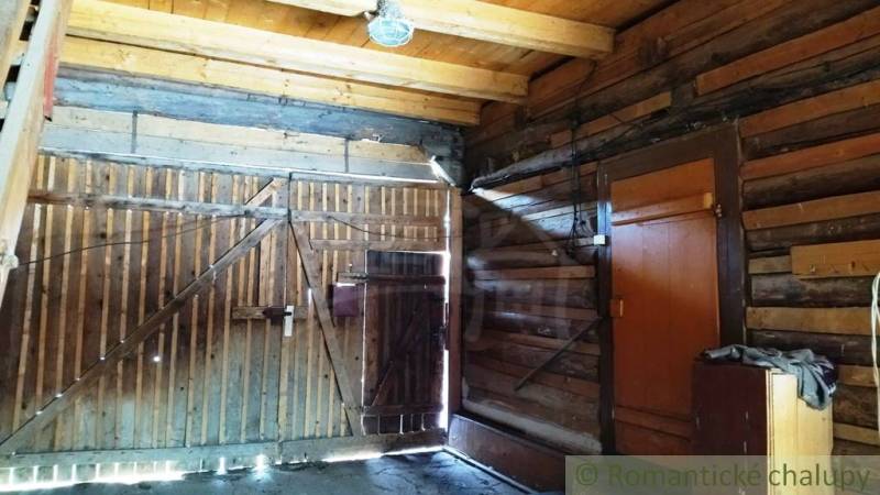 Interior of a wooden family house with a wooden gate and lighting.