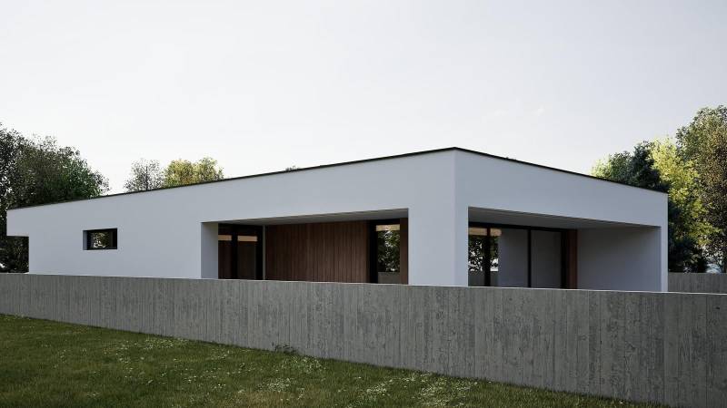 A family house in Nesvady with a white facade and wooden accents behind a concrete fence.
