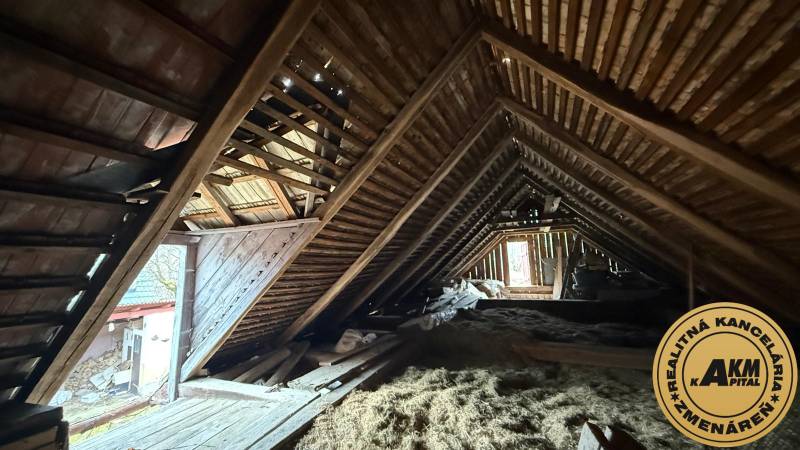 The attic of a family house with wooden beams and roofing in Babiná.