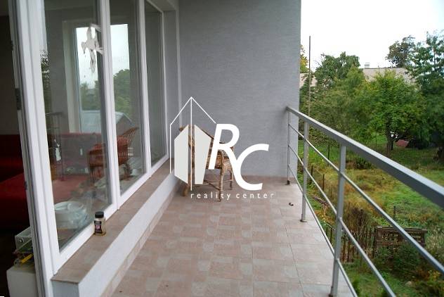 Terrace of a family house in Bystrička with glass walls and a panoramic view.