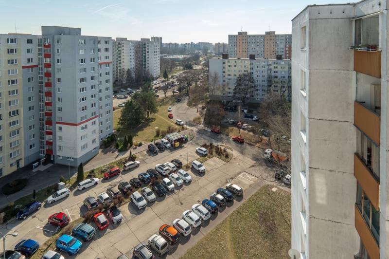 A view of apartment buildings and a parking lot on Ševčenkova Street in Bratislava - Petržalka.