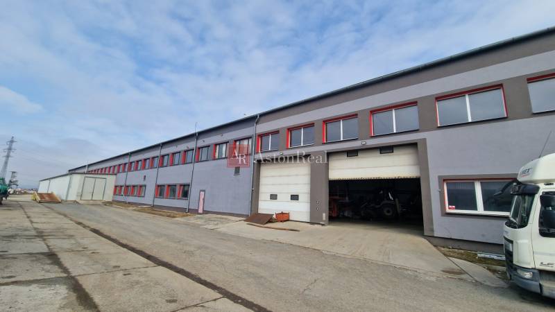 Warehouses and halls on Východná Street in Poprad, a gray building with red windows.