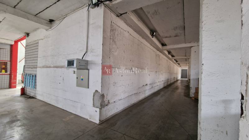 Industrial interior of warehouses and halls with concrete walls and lighting.