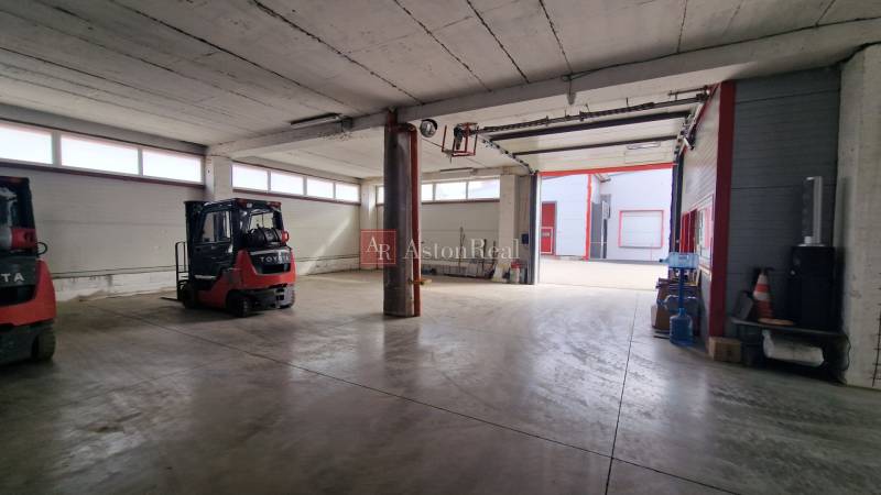 Warehouses and halls with forklifts and concrete floors.