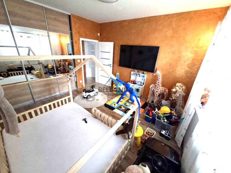 Children's room in a family house with toys, a bed, and cabinets. Floor with wooden decor.
