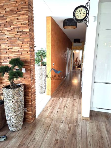 Interior of a family house with a decorative wall, wood-patterned flooring, and modern accessories.
