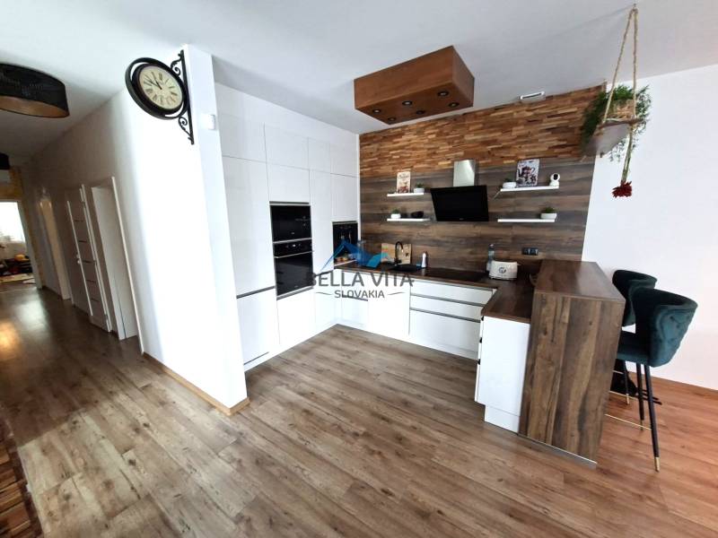 A kitchen in a family house with a wooden decor floor and modern kitchen equipment.