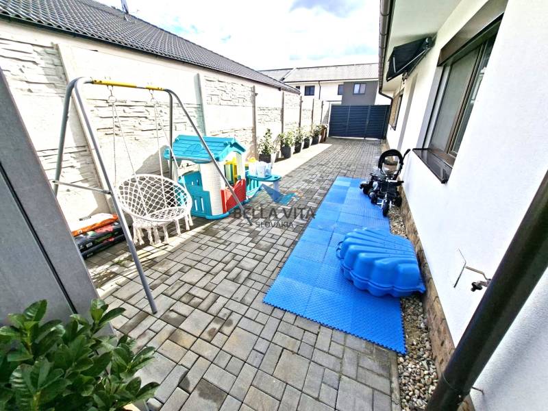 The yard at the family house on Mládežnícka Street in Galanta with a children's playground and a swing.