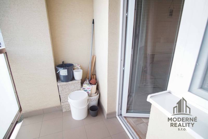 Balcony with storage needs in a 3-room apartment, tiles and glass doors.