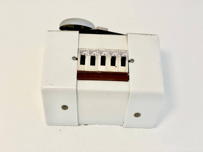 Living in a one-room apartment with a white plastic cover and switches.