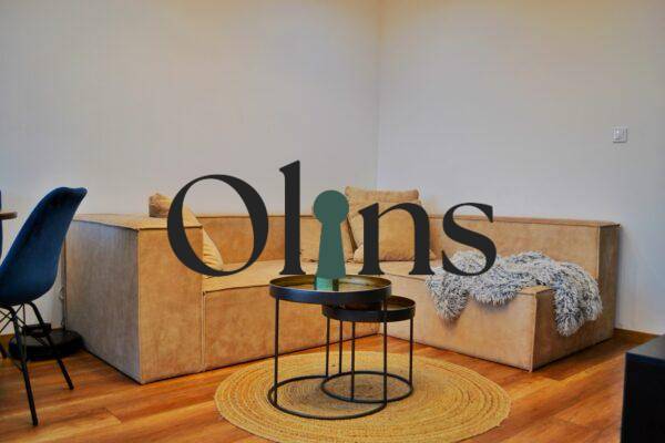 Living room in a 3-room apartment with a comfortable sofa and a floor with a wooden decor.