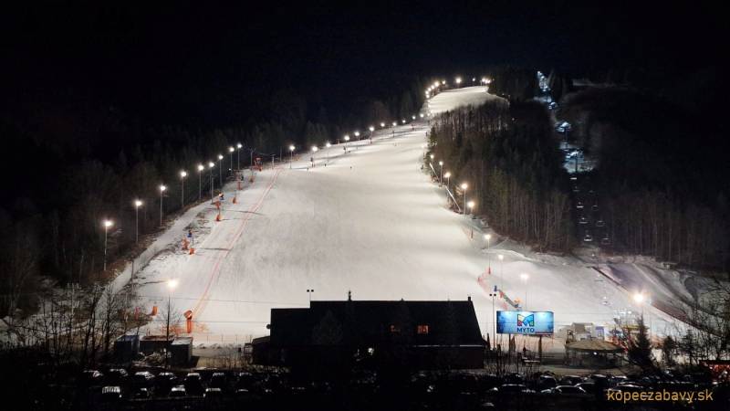 Night ski slope in Mýto pod Ďumbierom with lighting and a cable car.