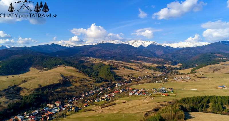 Aerial view of the picturesque village of Dolná Lehota with a mountain scenery behind it.