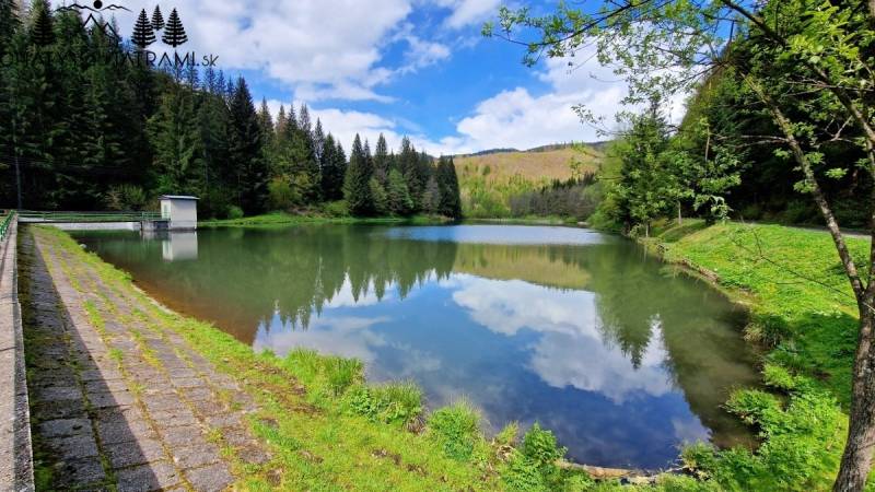 A peaceful body of water surrounded by forests in Dolná Lehota.