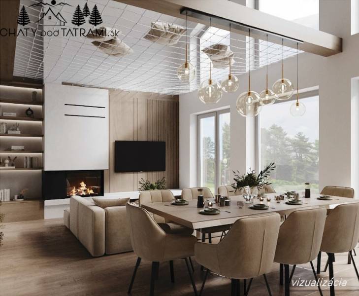 Interior of a cabin with a dining table, fireplace, and wooden decor flooring, illuminated by chandeliers.
