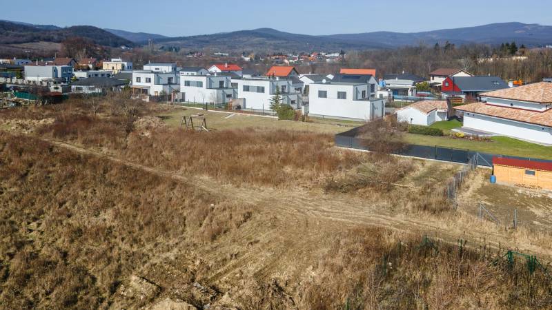 Land - housing in Pezinok with a view of modern development and the surrounding nature.