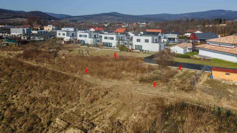 Pezinok, Land - housing: A view of unused land surrounded by houses and nature.