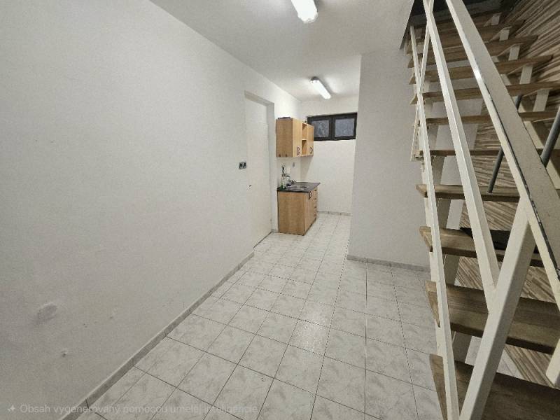 Interior with white walls, kitchen cabinet, staircase, and floor with wood decor.