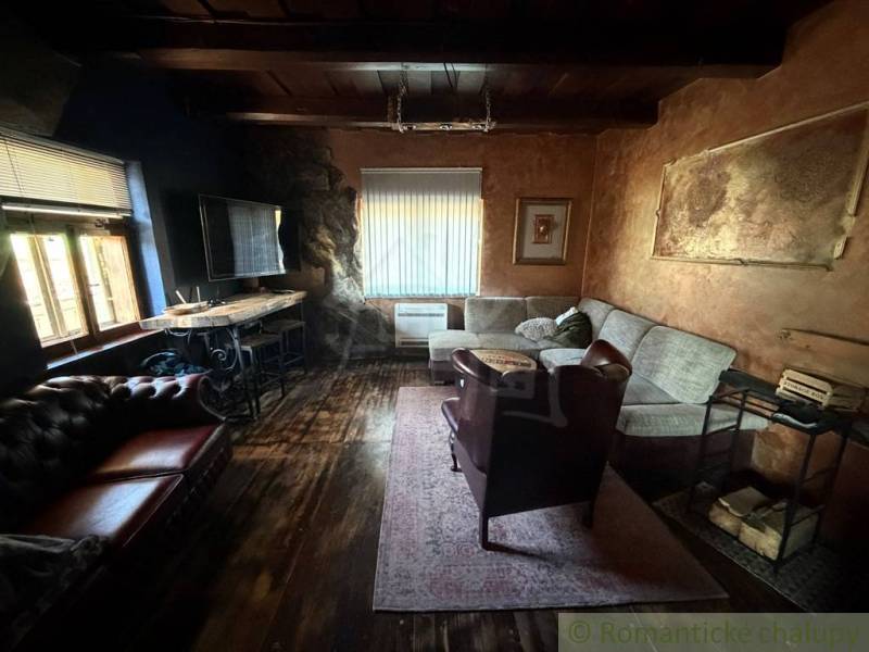 Living room in a family house with a wooden decor floor and comfortable seating.