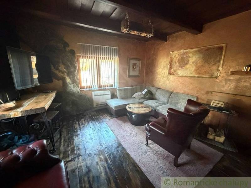 Living room in a family house with rustic furniture and a wooden decor floor.