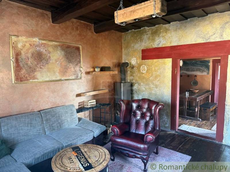 Living room in a family house with a leather armchair and a tiled stove.