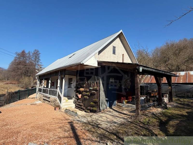 A family house in Ratkovské Bystré with a gable roof and a wooden veranda.