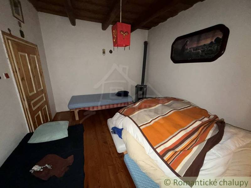 A room in a family house with wooden floor decor and simple furnishings.