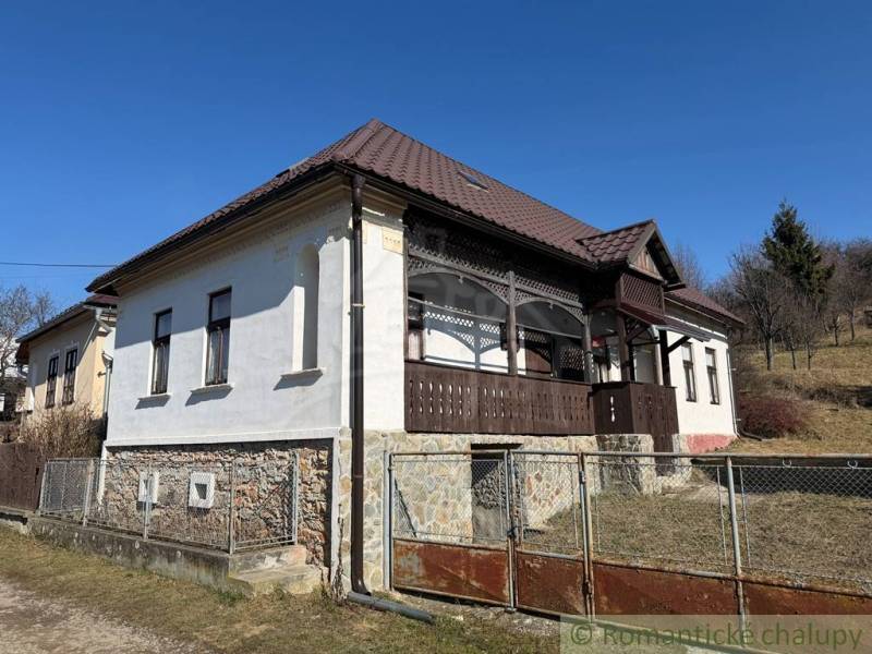 A family house in Lipovec with historical details, stone, and distinctive wooden veranda decor.
