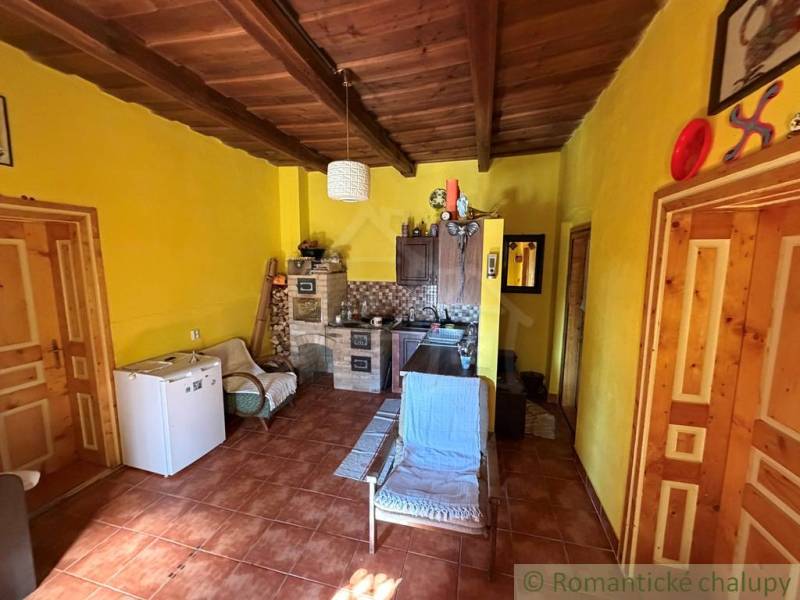 Interior of a family house with a wooden ceiling and yellow walls.