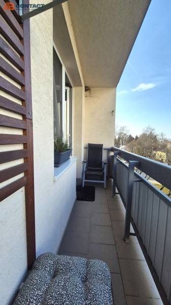 The balcony of a 2-room apartment on Bratislavská Street in Piešťany with comfortable seating and plants.