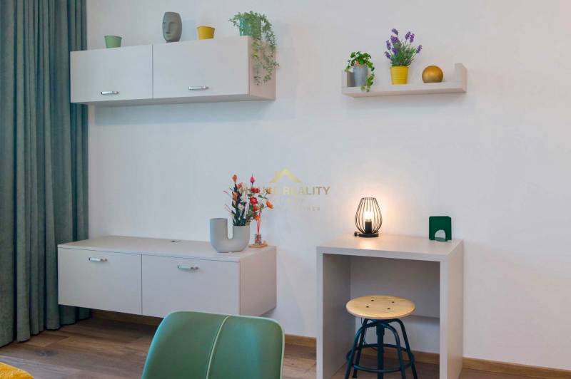 A minimalist interior with wood-decor flooring and furniture in a studio apartment.