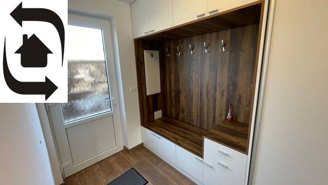 A wardrobe with hangers and cabinets, a floor with a wood decor. Family house.