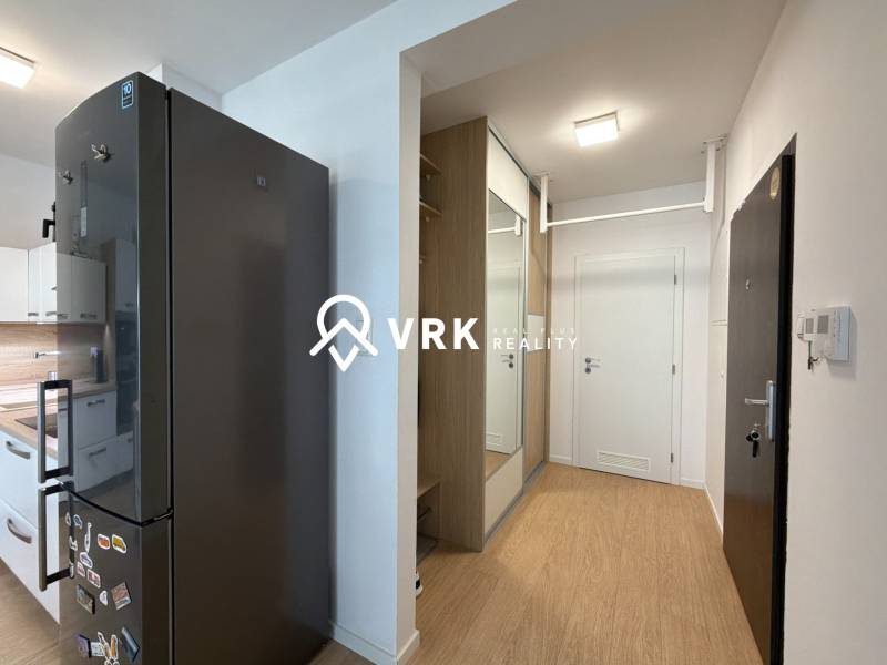 Kitchen and hallway in a 3-room apartment with a wooden decor floor.