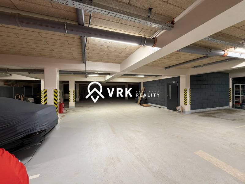 Underground parking lot with covered parking spaces and security features.