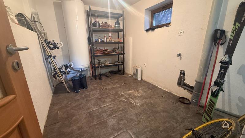 Storage space in a family house with a shelf and sports equipment, floor with wooden decor.