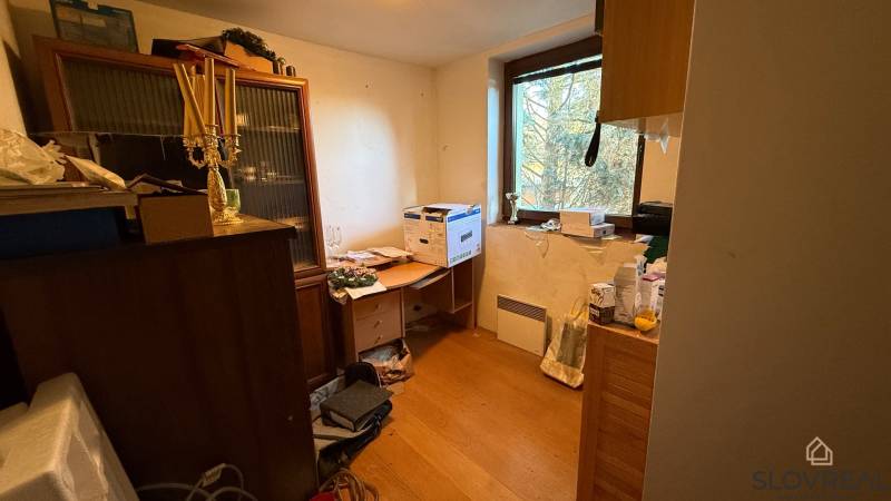 A room in a family house with furnishings and a wooden decor floor.